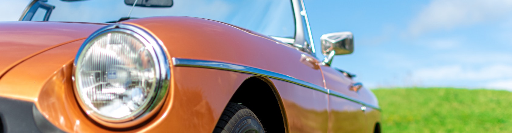 orange mg collectors car on grass