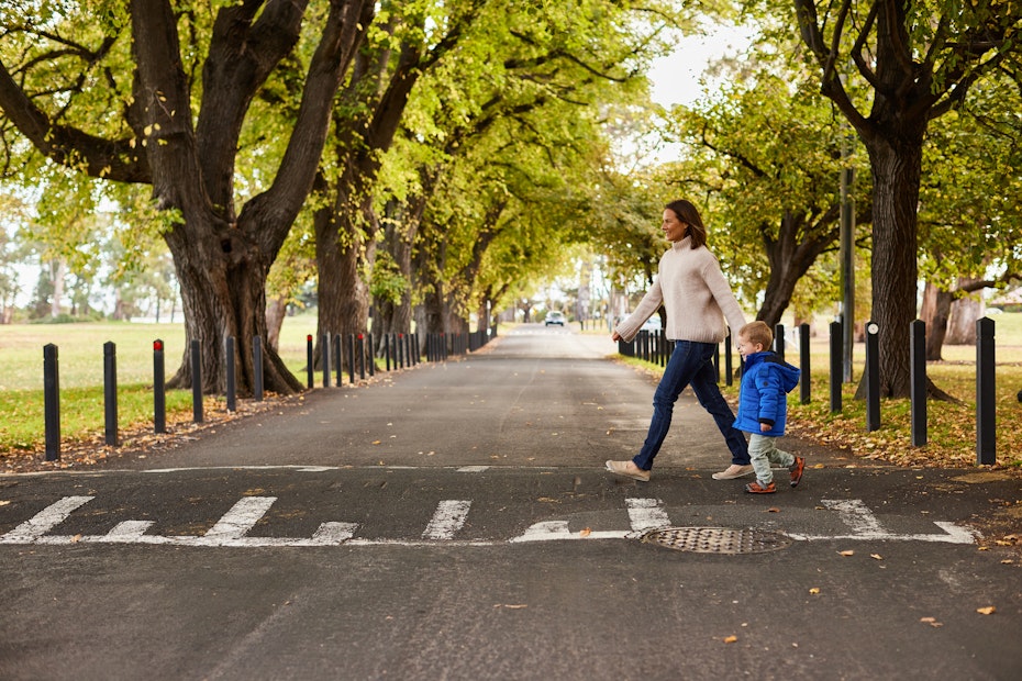 woman walking child across road