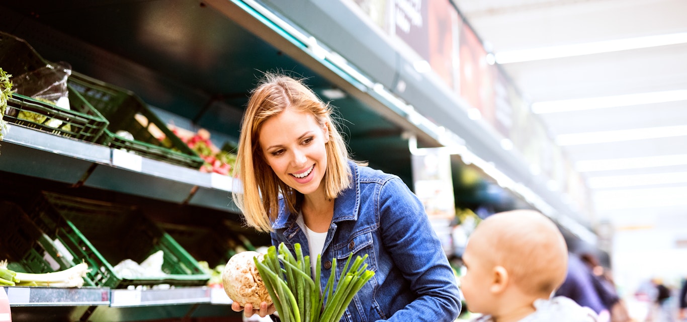 Woolies egift cards hero Woman grocery shopping with infant son
