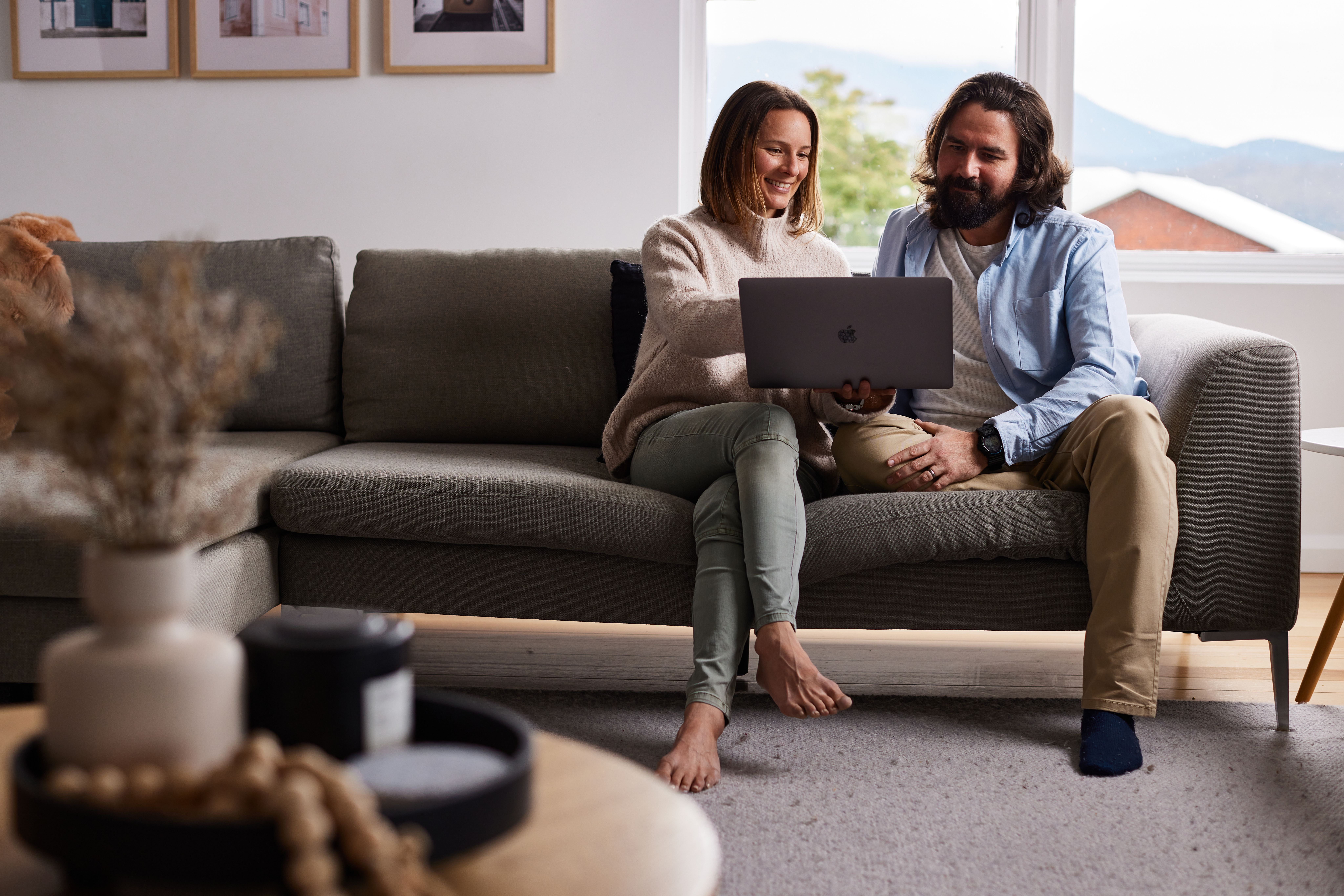 couple looking at laptop on couch