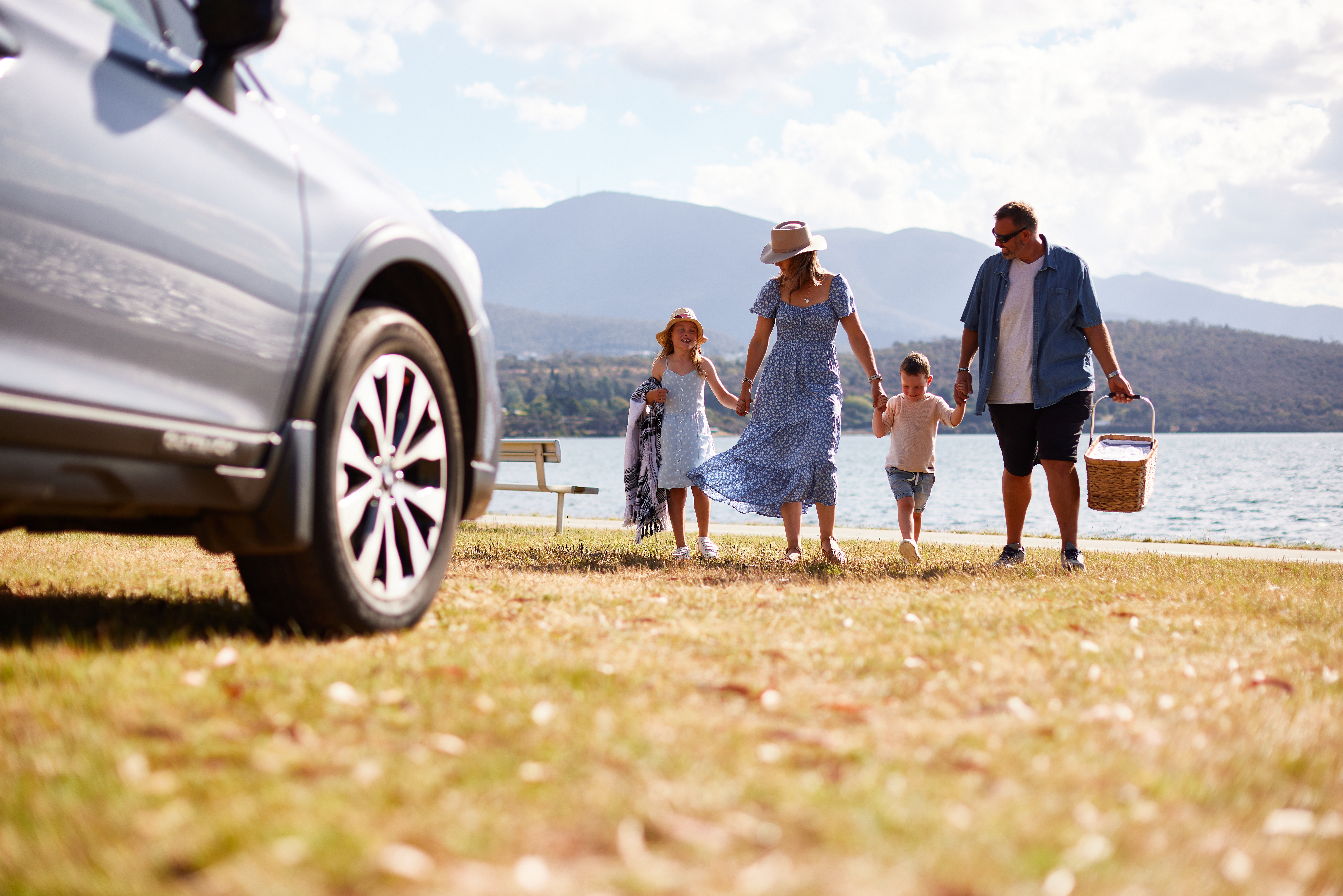 A happy family taking a road trip on a sunny day.