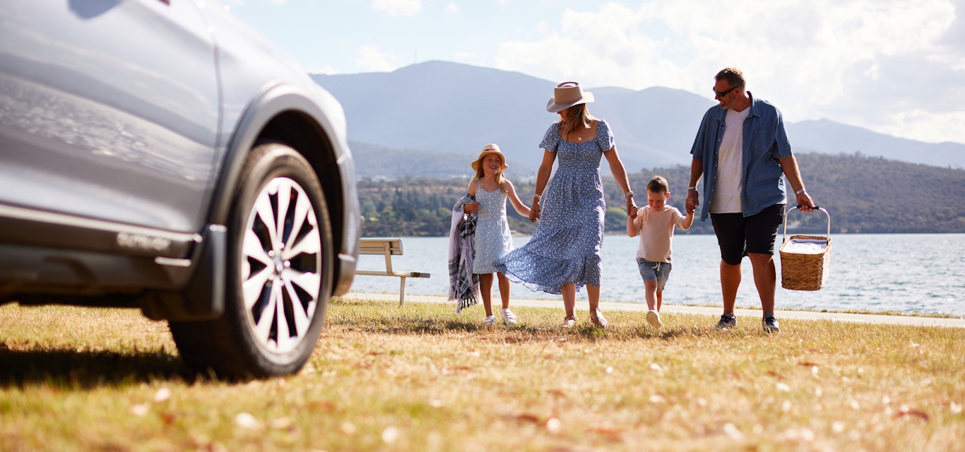 A happy family taking a road trip on a sunny day.