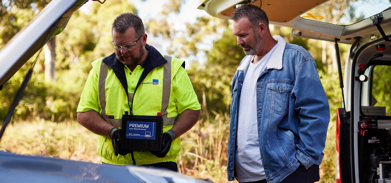 Roadside patrol holding a replacement battery 