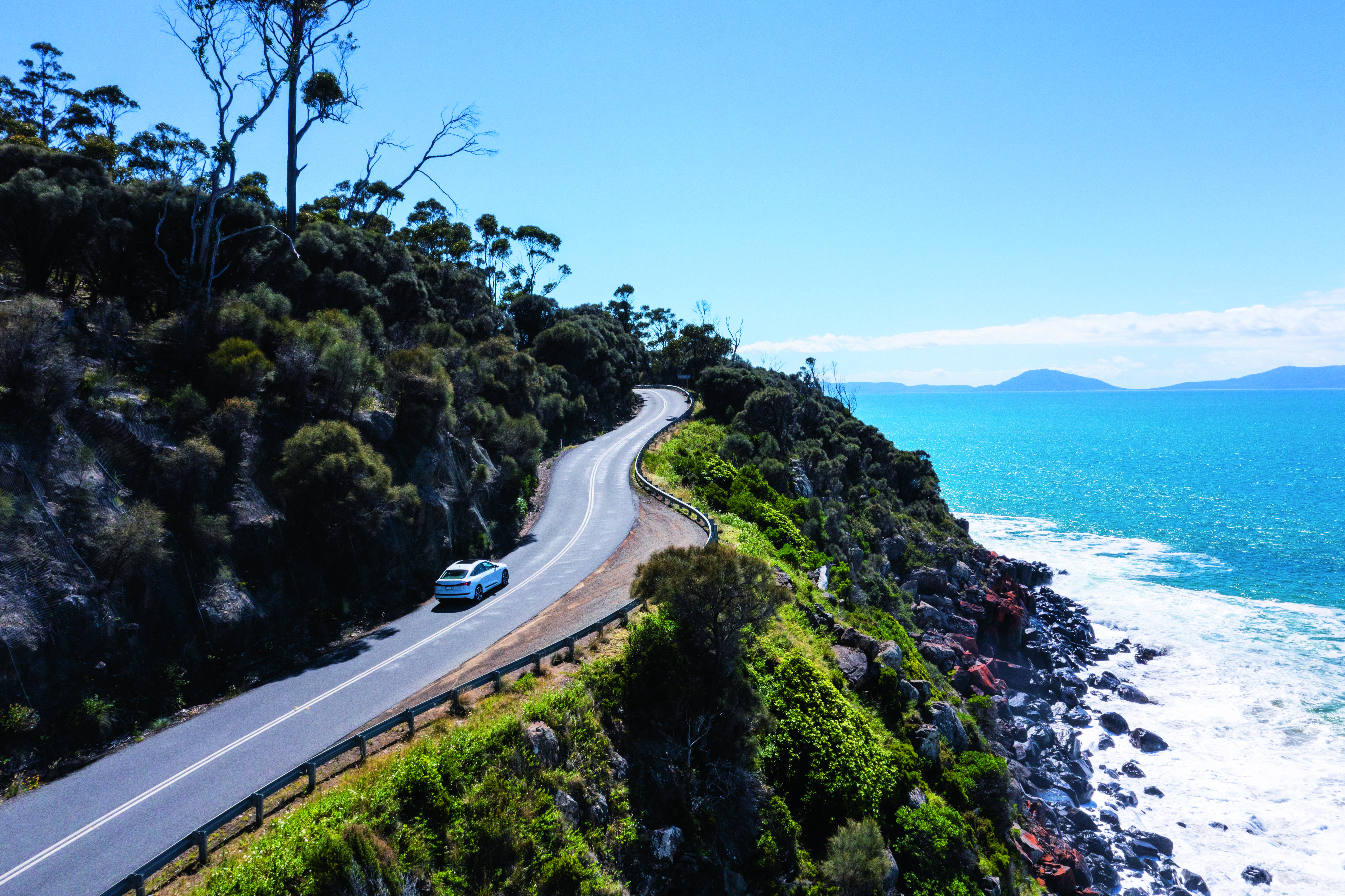 car driving up winding road