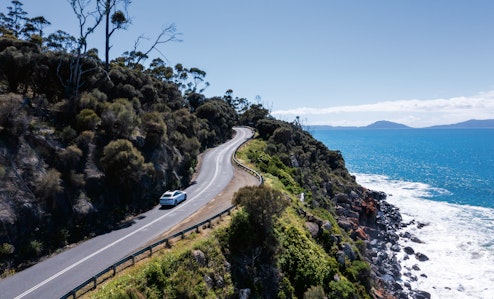 car driving up winding road