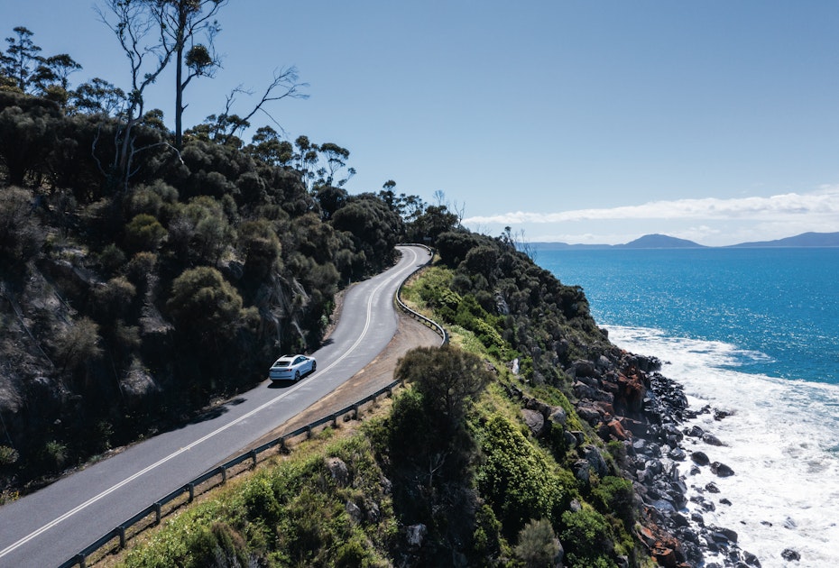 car driving up winding road