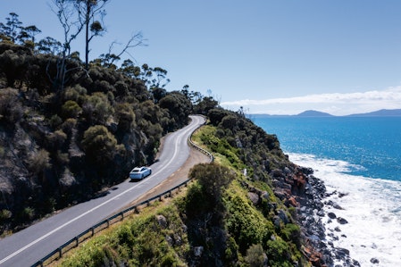 car driving up winding road