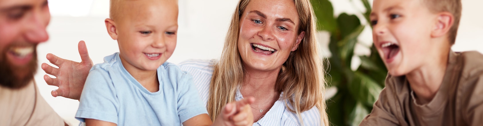 Family with young children playing a board game