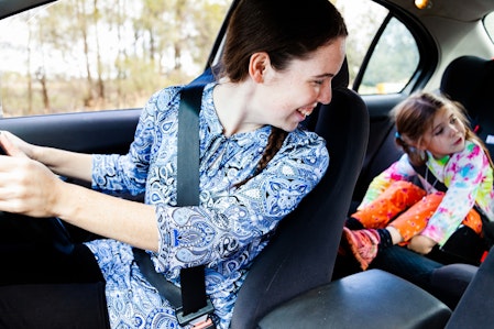 Mum looking back at children in back seat of car