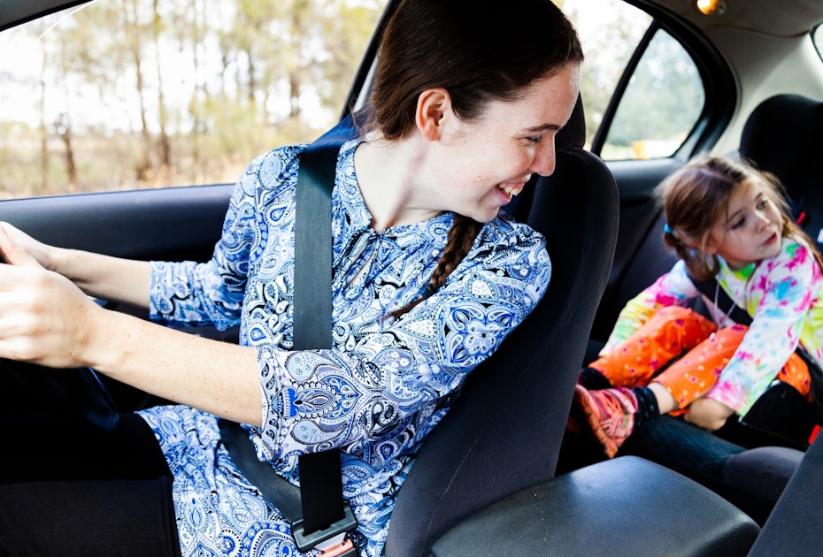 Mum looking back at children in back seat of car