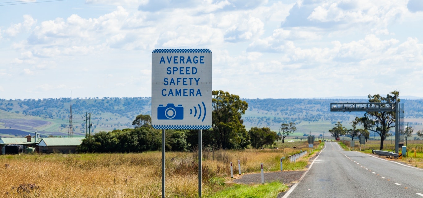 highway with speed camera sign