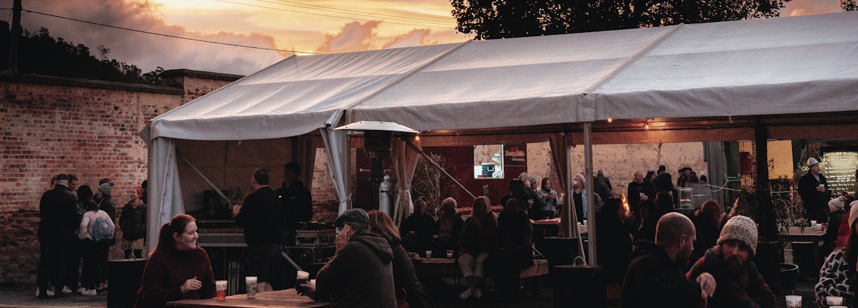 sunset over marquee and tables outside