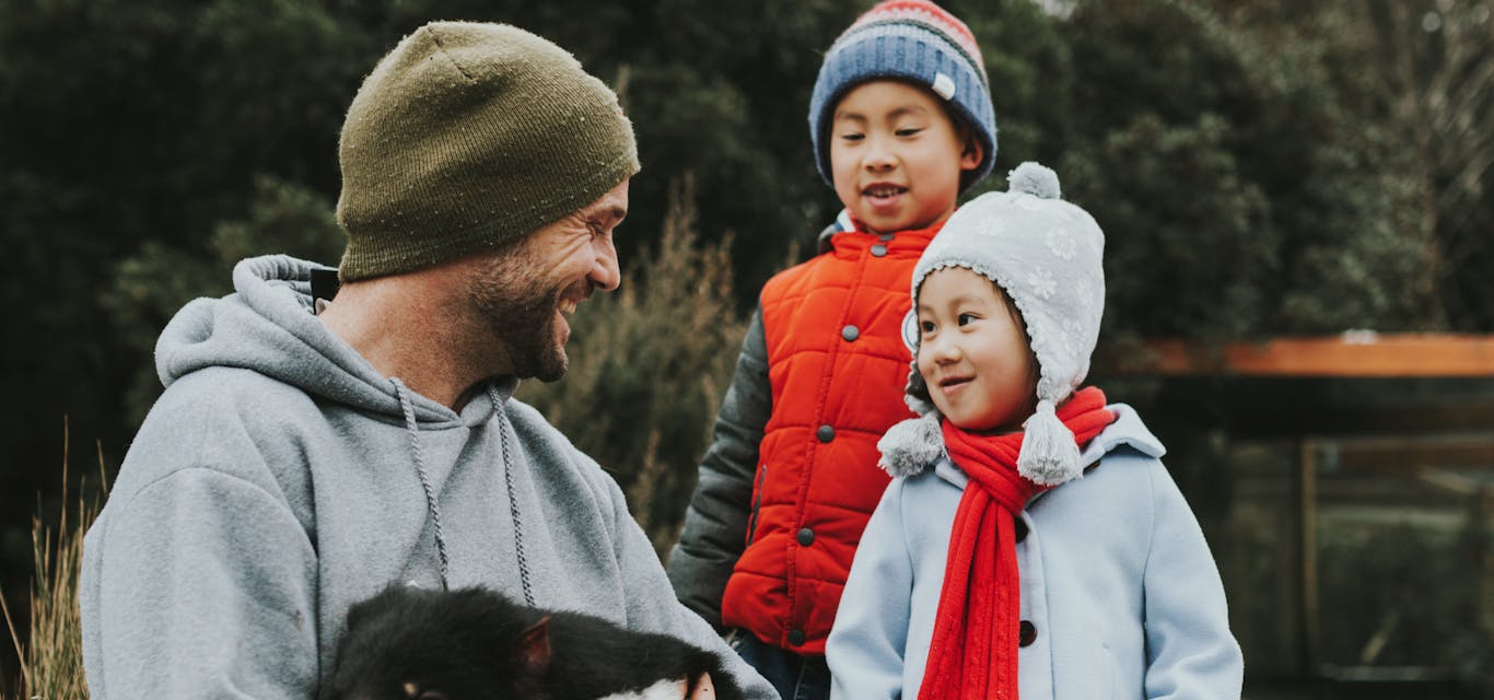 Get up close to wildlife at Devils Cradle Mountain family holding tassie devil