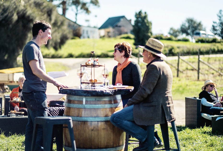 Enjoying wines round a barrell