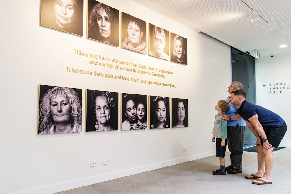 family looking at faces on the wall