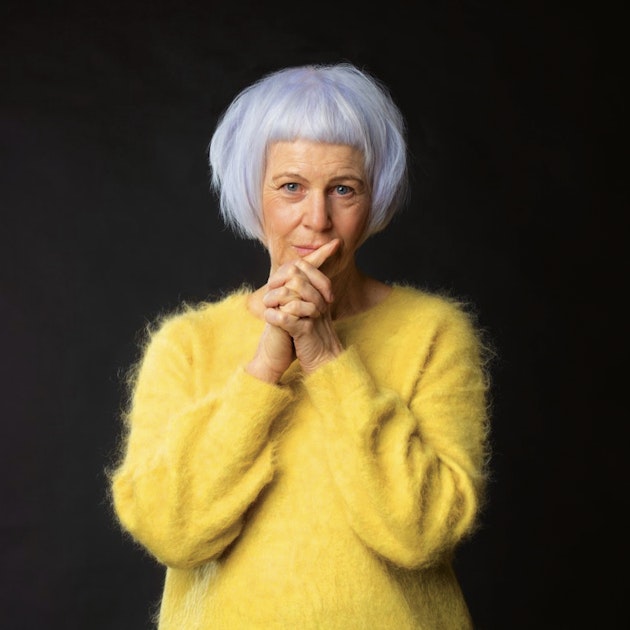 Joan Didion in yellow jumper