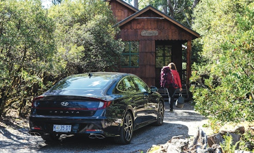 car parked walking into cabin
