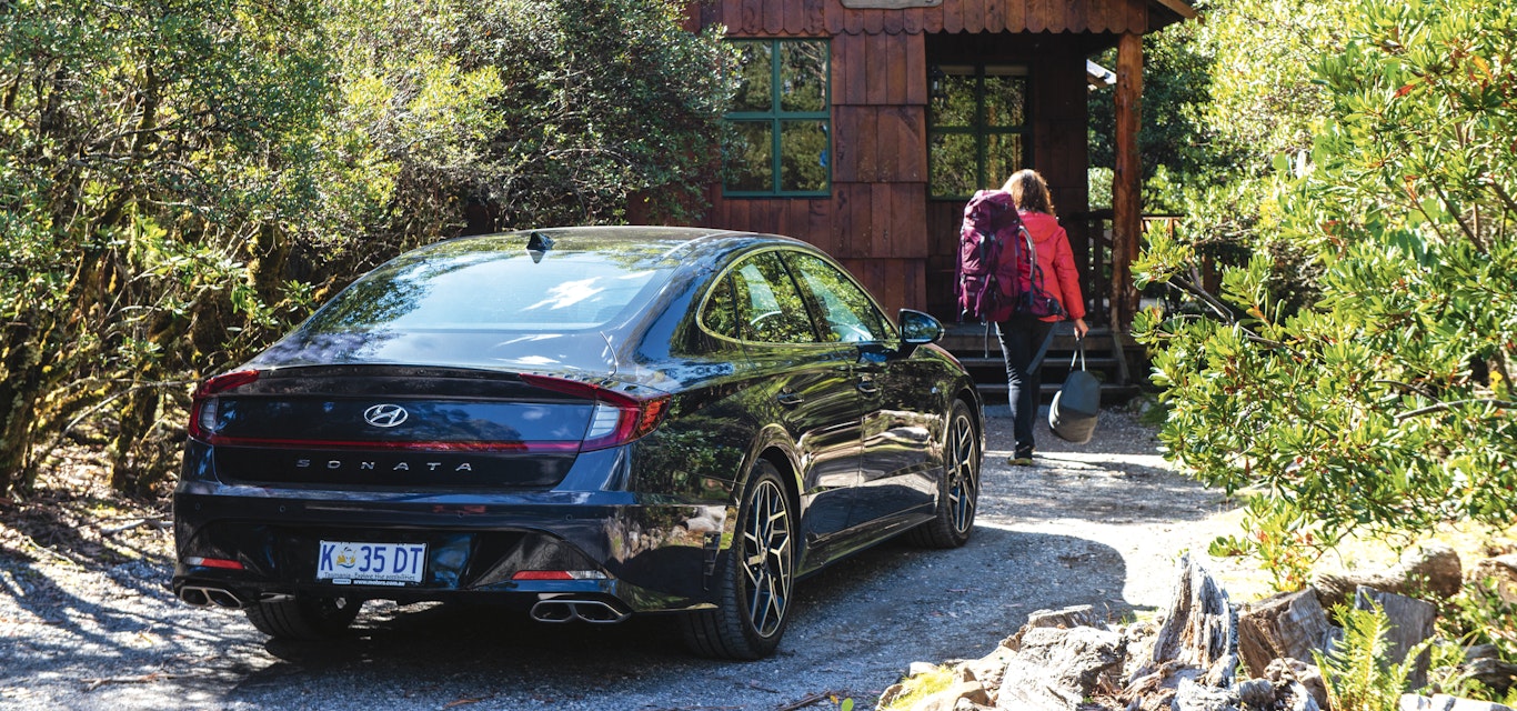 Heading to Cradle Mountain Highlanders cabins car parked walking into cabin