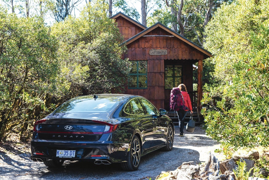 car parked walking into cabin