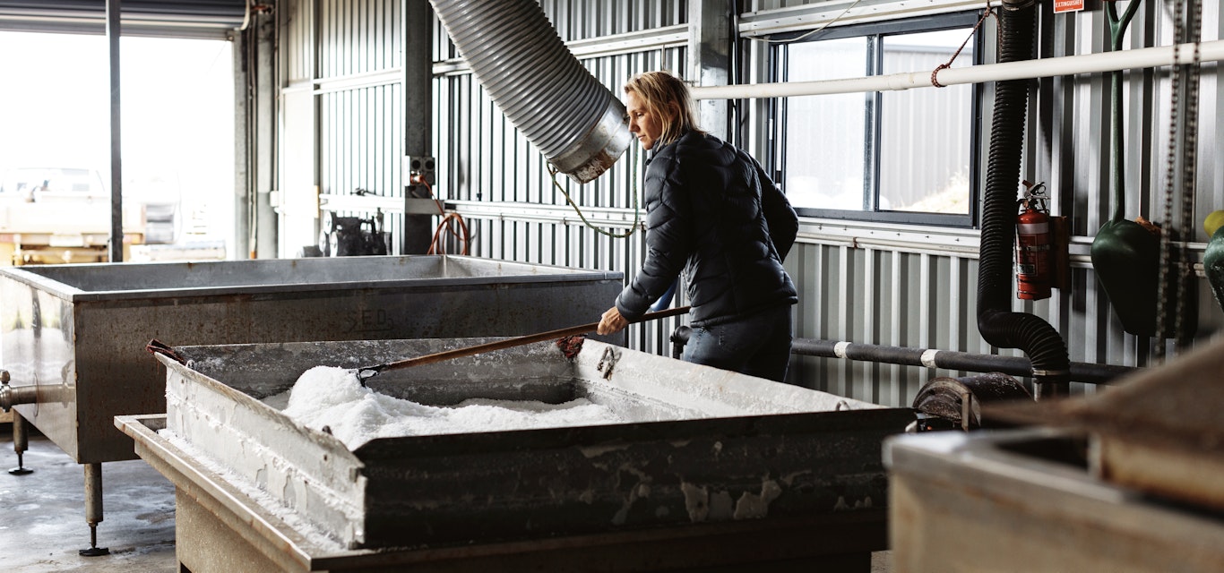 Alice Laing at work shovelling salt in shed