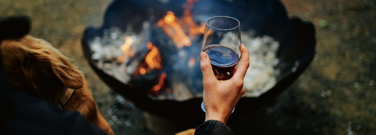 drinking red wine by fire pit