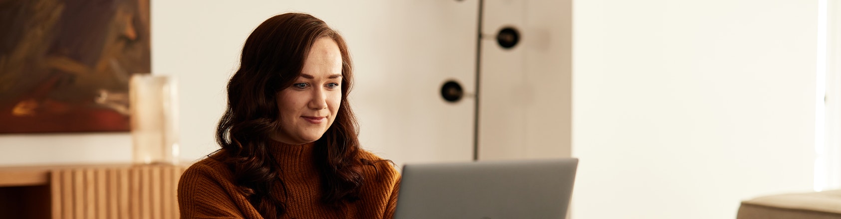 Woman sitting at a table using a laptop