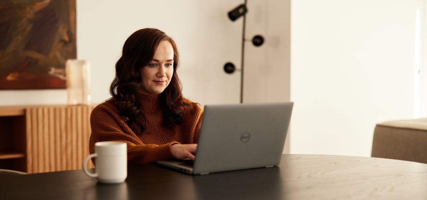 Woman sitting at a table using a laptop