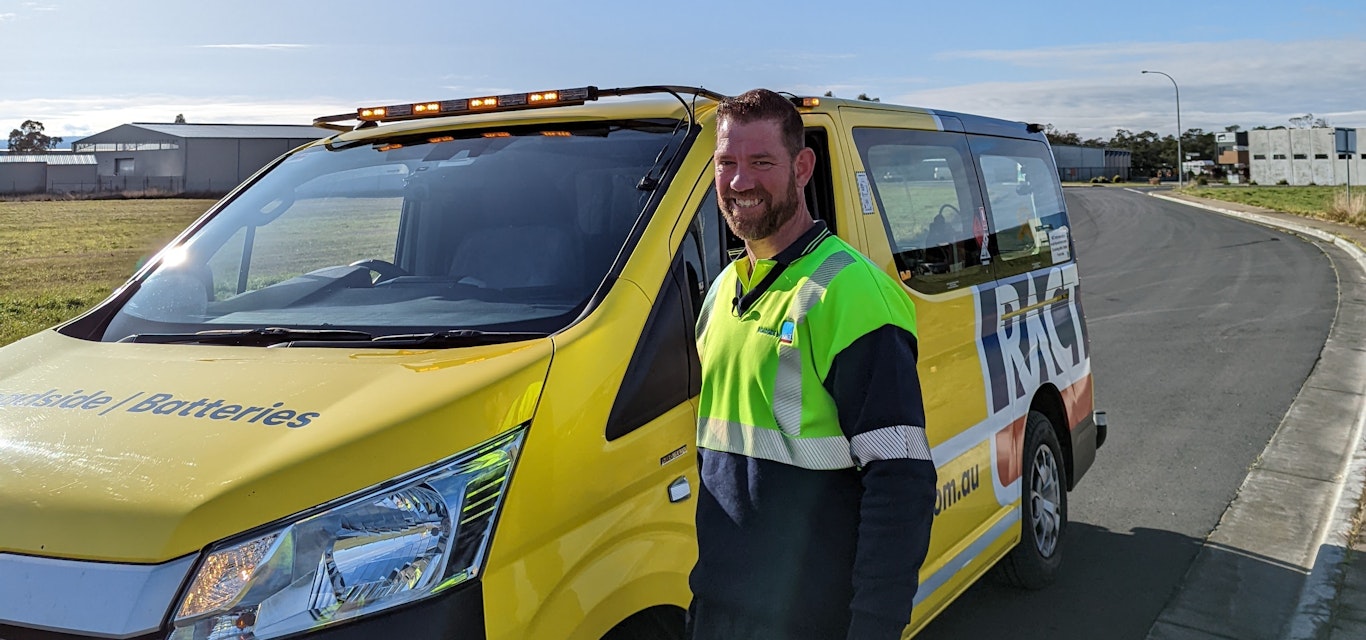 Tim standing beside van on side of road.