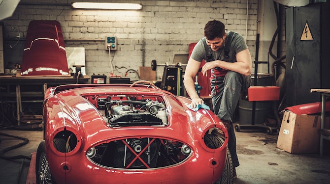 working on car in garage