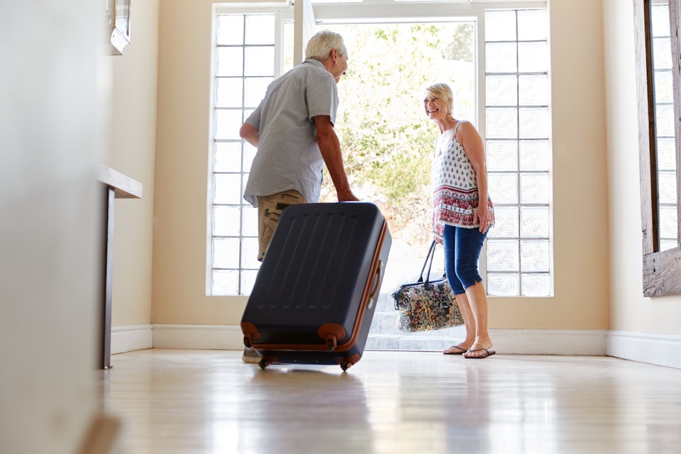 walking out door with suitcase