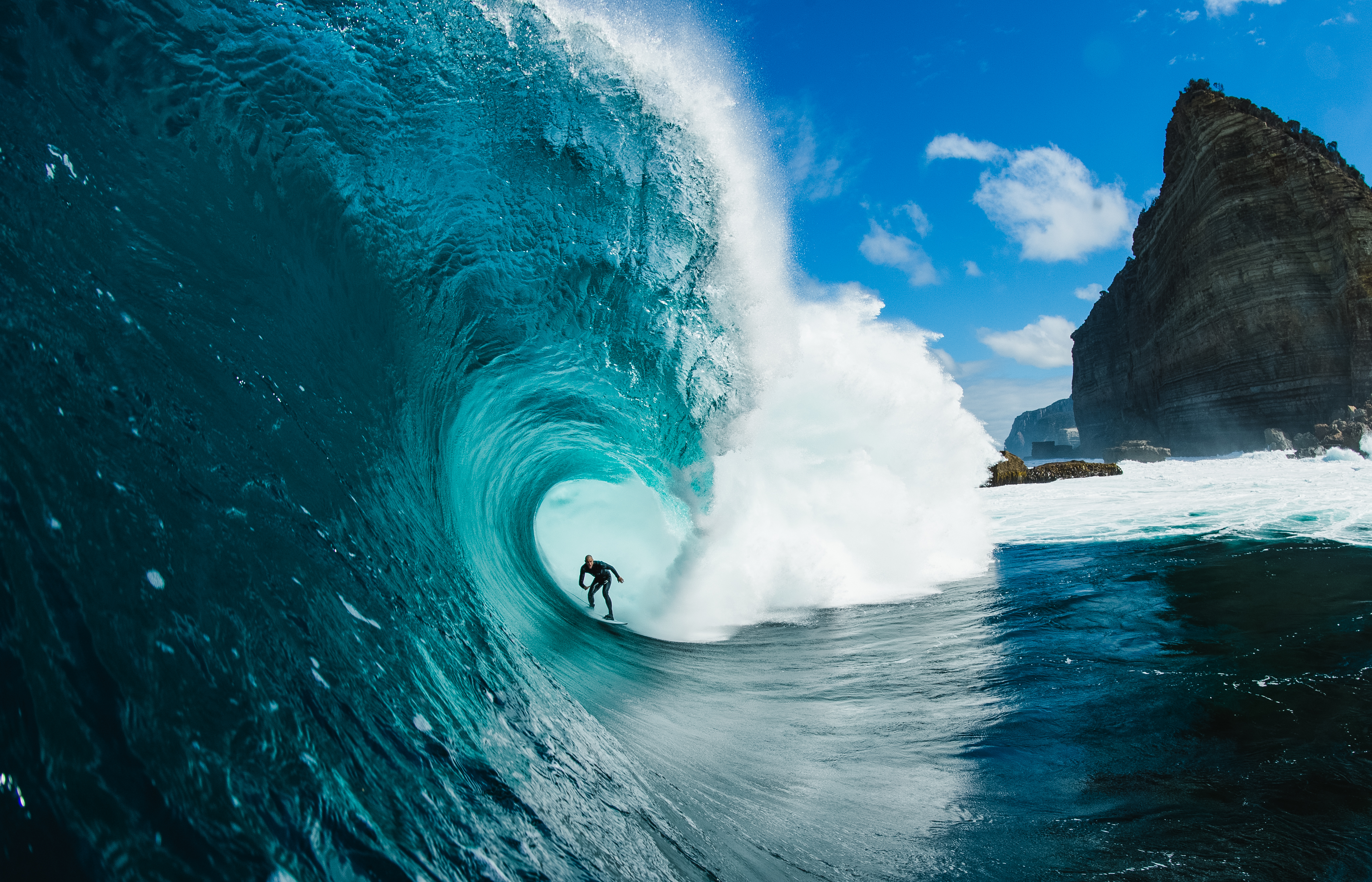 Surfer in barrel of wave off shipstern bluff