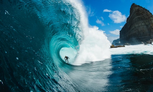 Surfer in barrel of wave off shipstern bluff