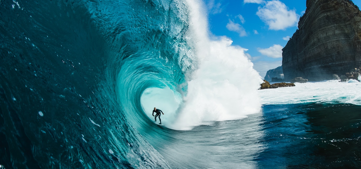 Surfer in barrel of wave off shipstern bluff