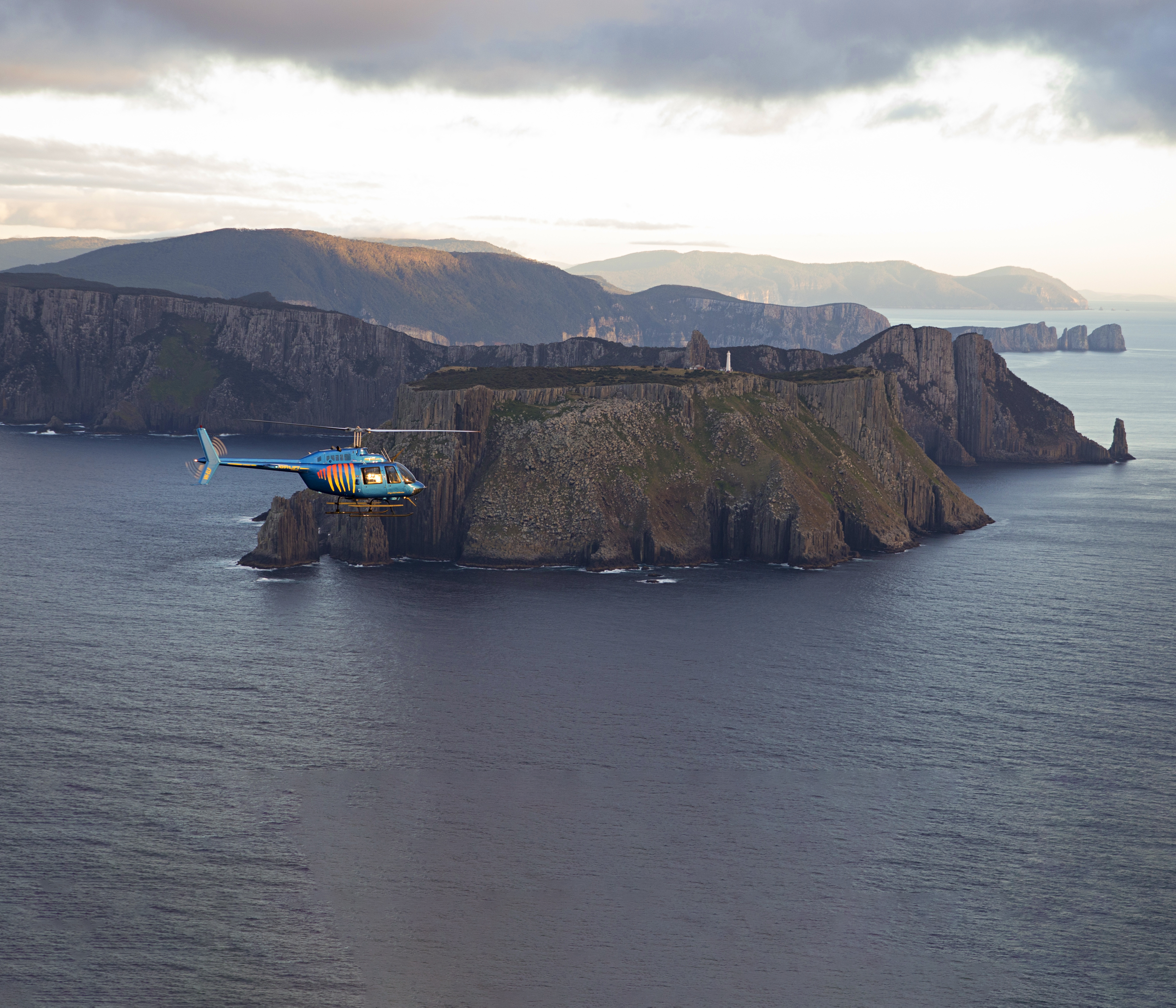 Helicopter flying over coastline