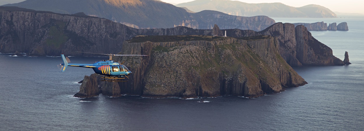 Helicopter flying over coastline