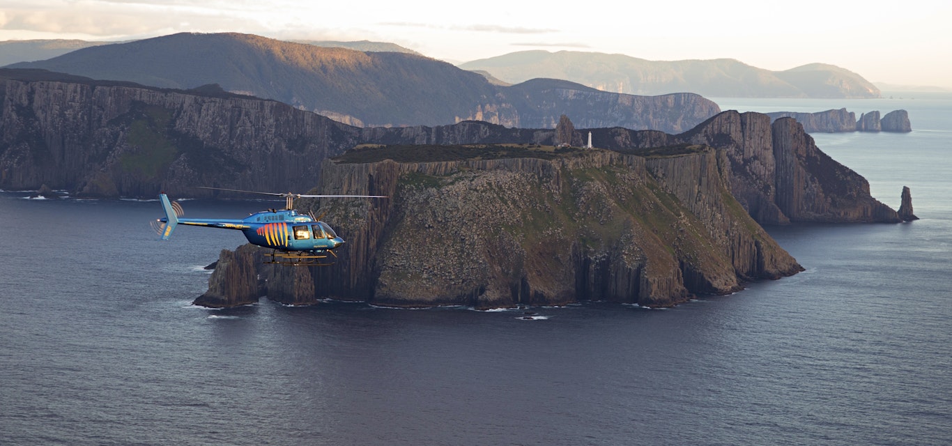 Helicopter flying over coastline
