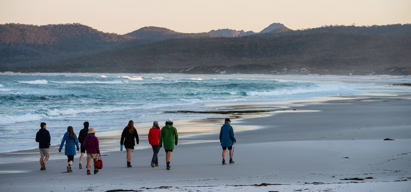 People walking along beach