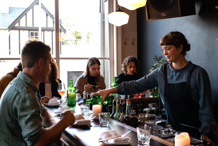 Rachelle pouring water at bar