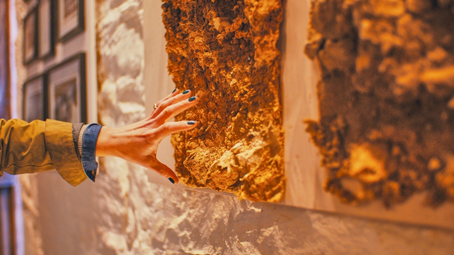 Hand touching rock