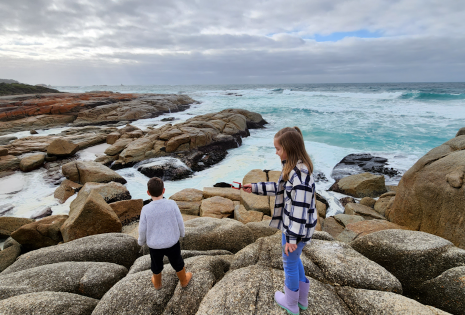 Kids exploring on rocks at the beach