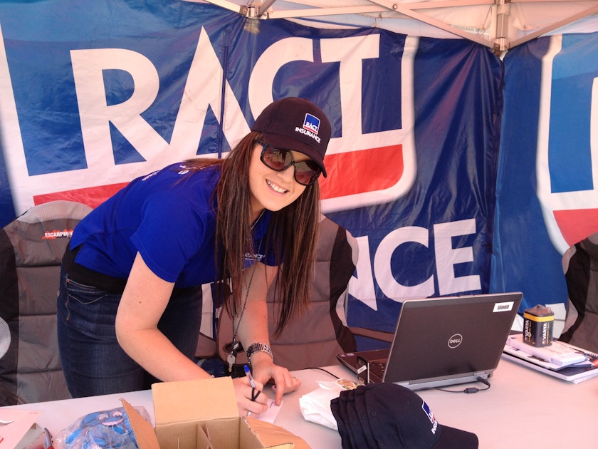 woman in marquee writing with laptop