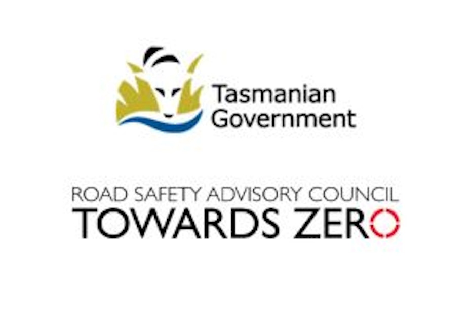 the Tasmanian government logo which depicts a stylised thylacine hiding in grass near water. Below that is the text-based logo for the road safety advisory council above the words 'Towards Zero'