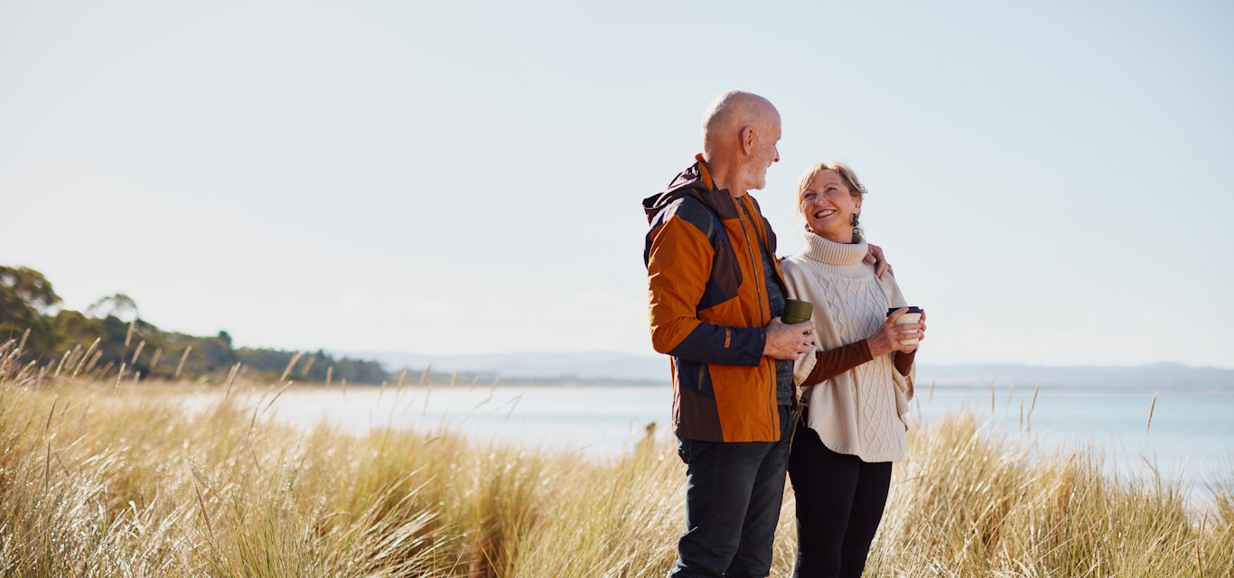 Senior couple standing near the beach
