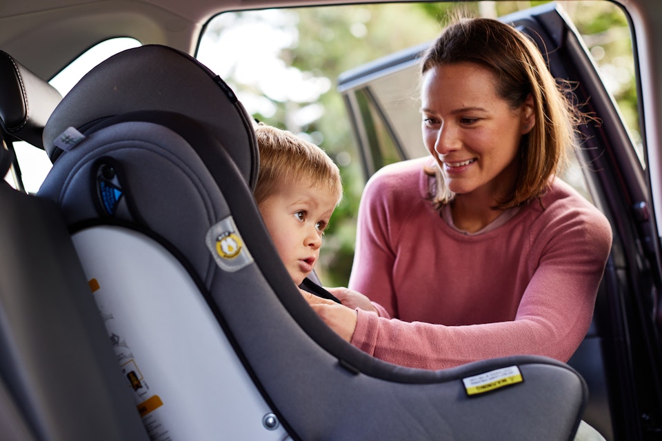 woman with child in car seat