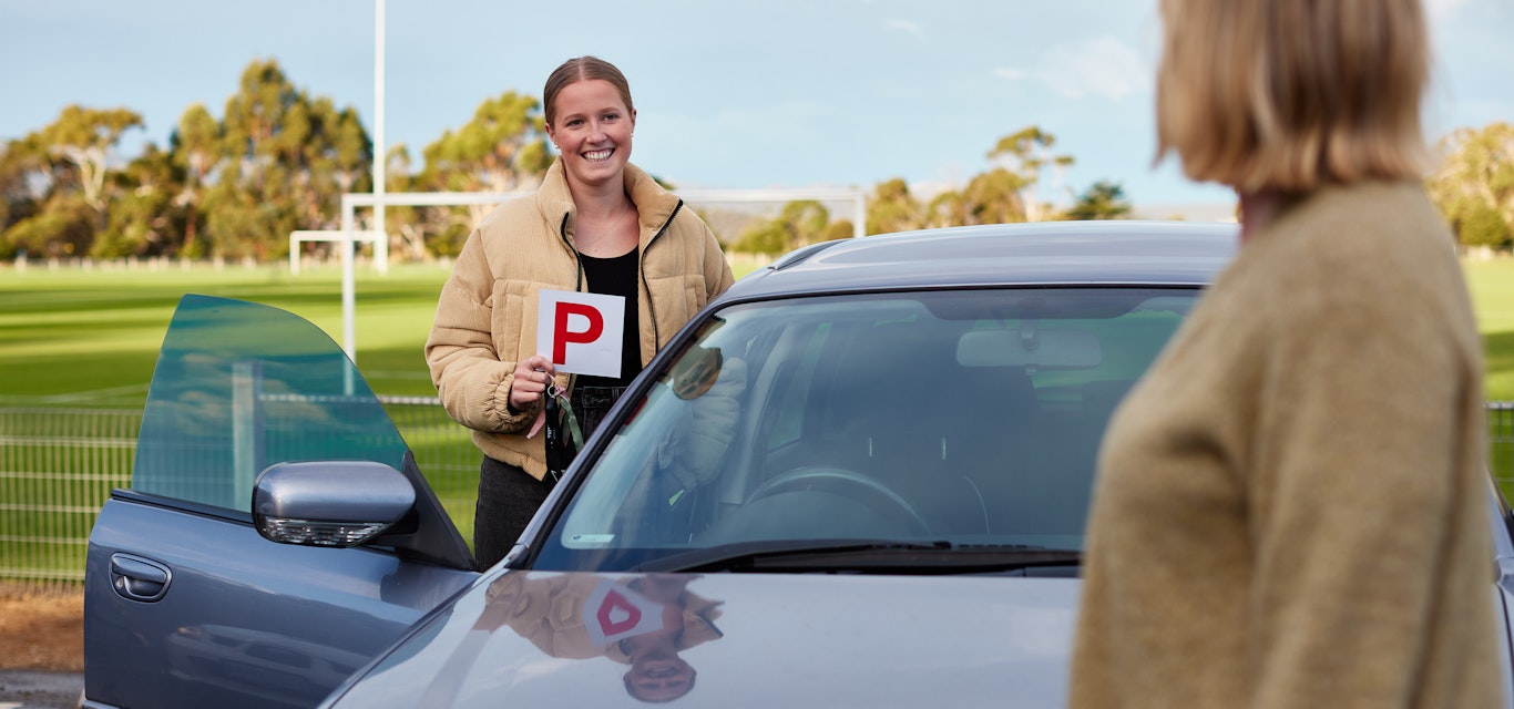 Girl putting up P plate
