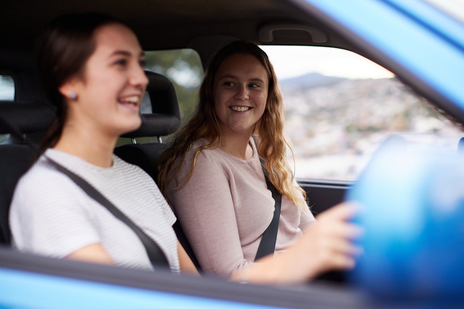 Two girls driving a car