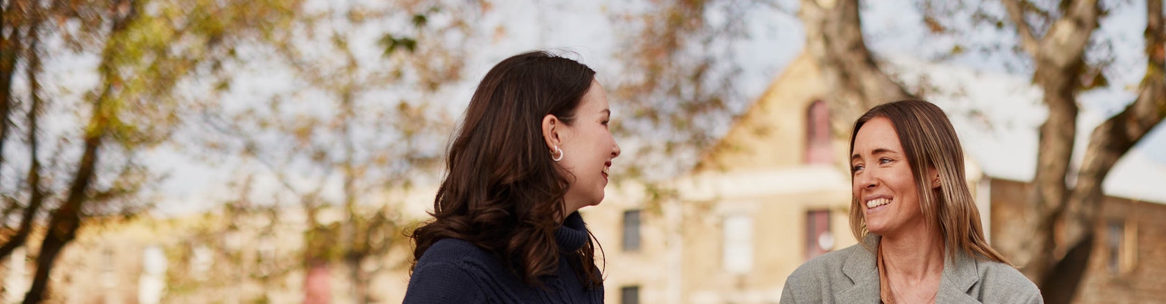 Women outside drinking take away coffee