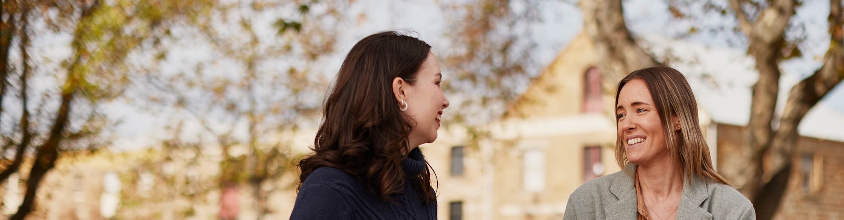 Women outside drinking take away coffee