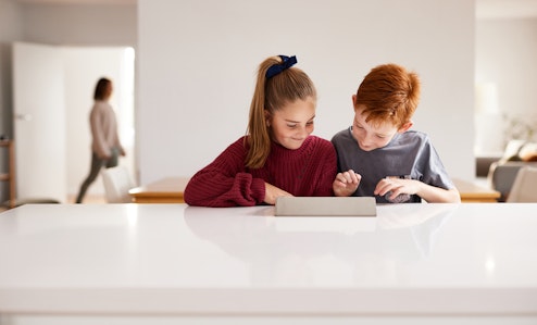 Two children looking at device 