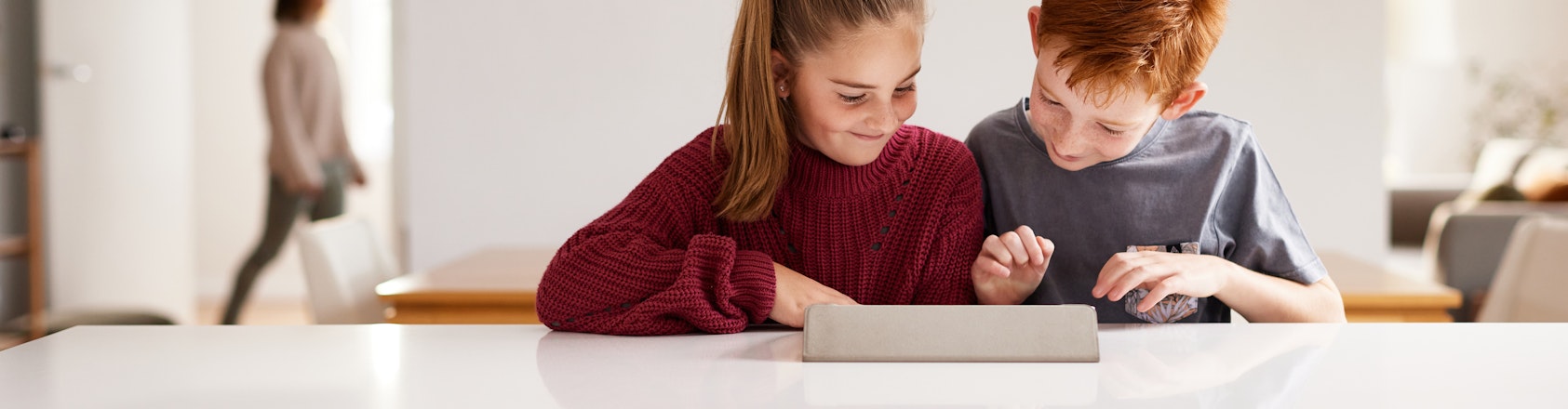 Two children looking at device